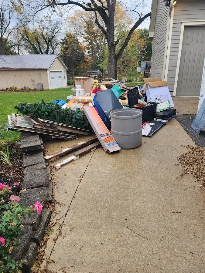 Dumpster being loaded with debris for 10 Yard Dumpster Rental in Ferguson